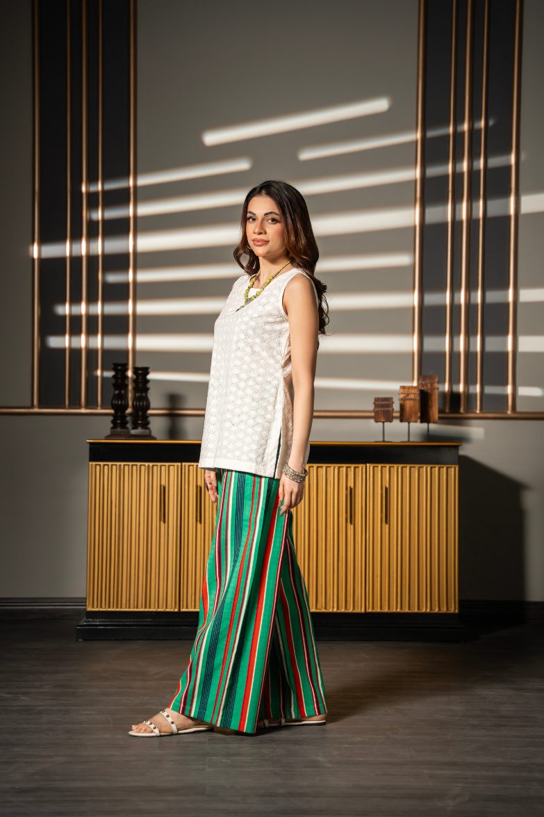 Daydream Set by Posheri, side view of white embroidered sleeveless top with green and red striped wide-leg pants