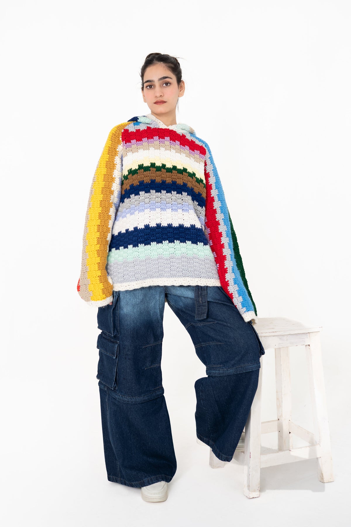 Colour Out Loud multicolour handmade crochet hoodie by Posheri, front view with contrasting striped sleeves, styled with wide-leg cargo denim