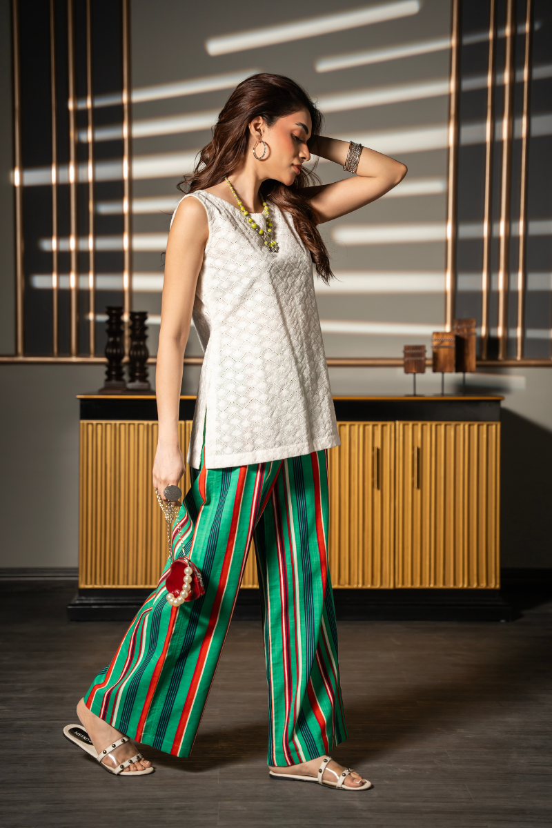 Daydream Set by Posheri, angled view of white embroidered sleeveless top with green and red striped wide-leg pants