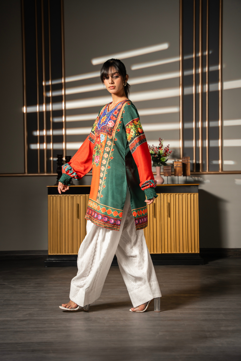Three-quarter view of Floral Folklore emerald green printed kurta with colorful floral print and balloon sleeves by Posheri