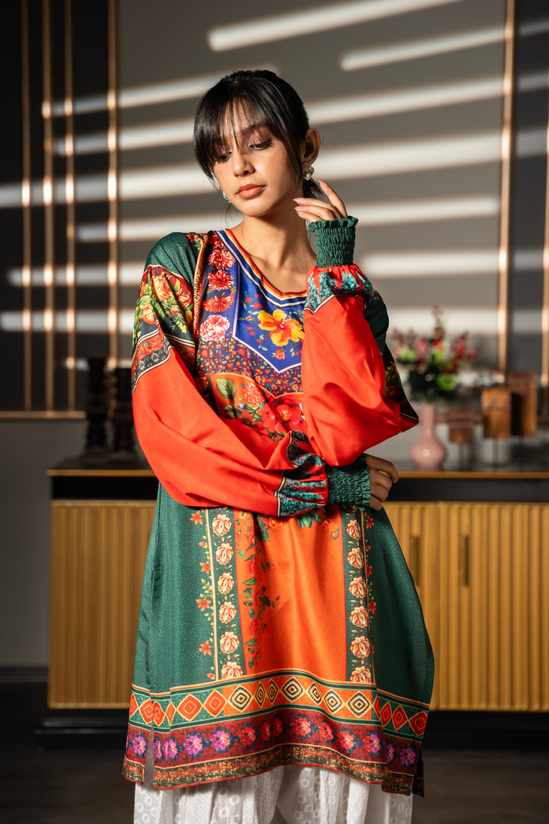 Close-up of Floral Folklore emerald green kurta showing colorful floral print, orange balloon sleeves and smocked cuffs by Posheri