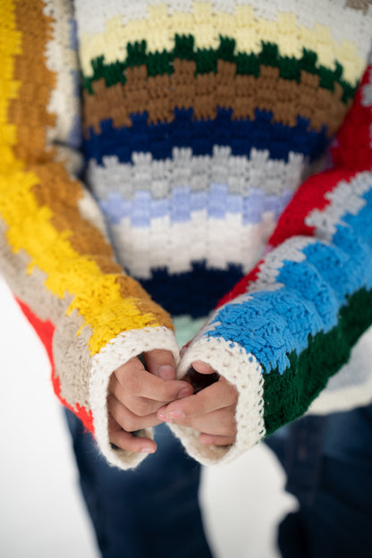 Close-up of the Colour Out Loud hoodie's hand-crocheted multicolour stripes and texture
