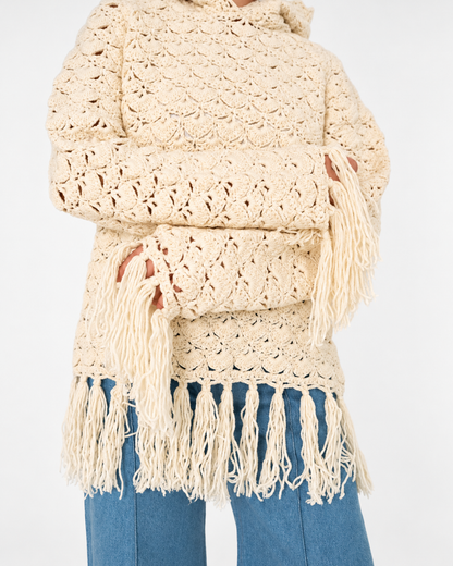 Close-up of the Fringe Benefits hoodie's hand-crocheted openwork pattern and long ivory fringes