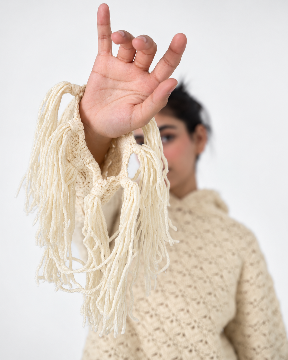 Detail of the knotted fringe cuff on the Fringe Benefits ivory handmade crochet hoodie