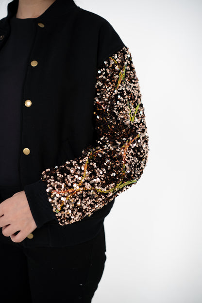 Close-up of Gilt Trip bronze-gold sequinned sleeve and gold-tone snap buttons – POSHERI