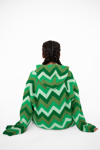 Model seated wearing Green Light green chevron crochet hoodie, back view – POSHERI Loop de Loop