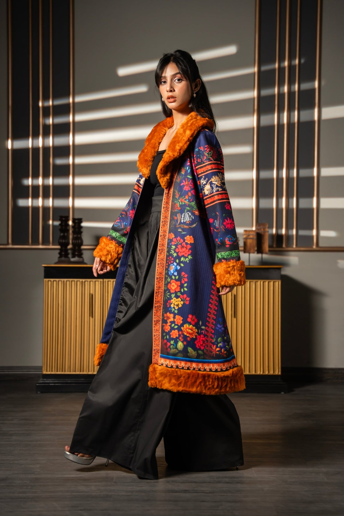 Jeans Poshak open-front winter coat, model walking in wide-leg black trousers
