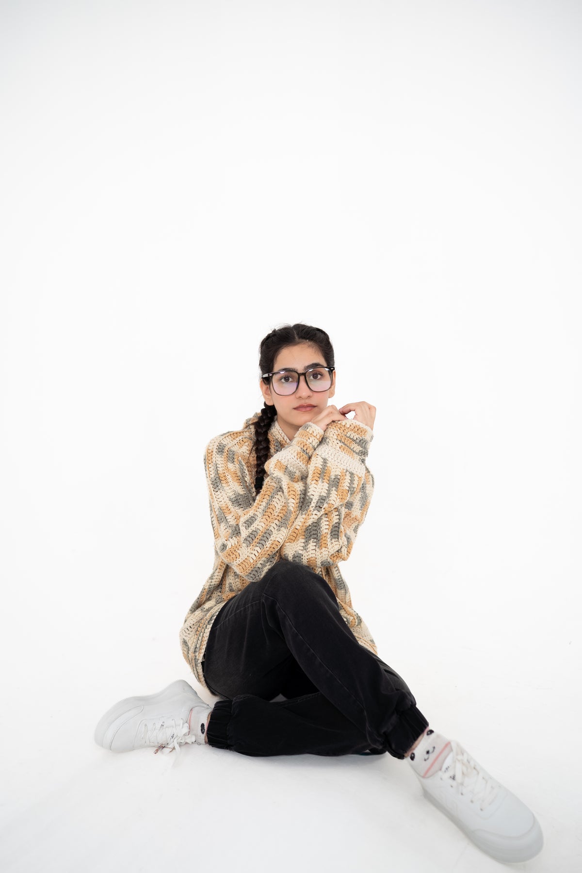 Model sitting on the floor in Latte Lines neutral multitone crochet hoodie – POSHERI Loop de Loop
