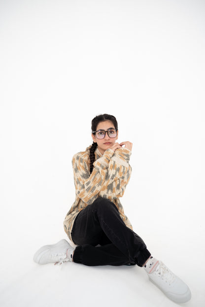 Model sitting on the floor in Latte Lines neutral multitone crochet hoodie – POSHERI Loop de Loop