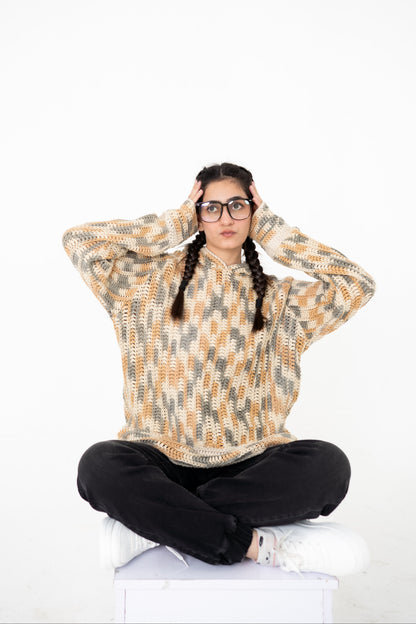Model seated cross-legged wearing Latte Lines cream, beige and grey crochet hoodie – POSHERI Loop de Loop