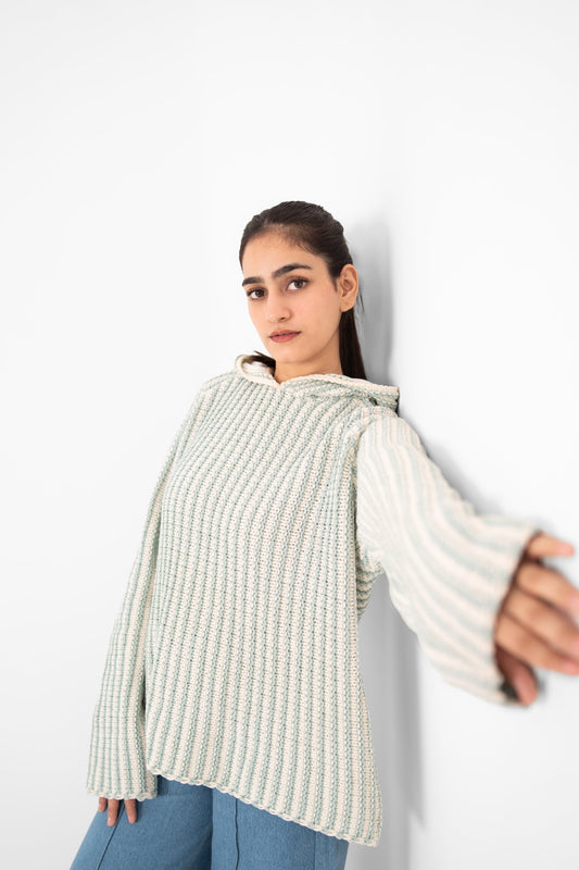 Mint Condition handmade mint and ivory ribbed crochet hoodie, model leaning against a white wall