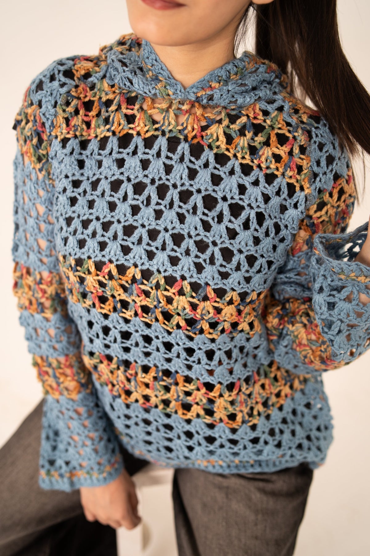 Mosaic Mood handmade dusty blue openwork crochet hoodie front close-up with multicolour yarn bands