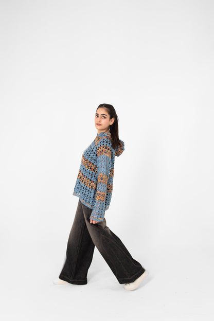 Mosaic Mood openwork crochet hoodie side view, model walking in wide-leg washed black jeans