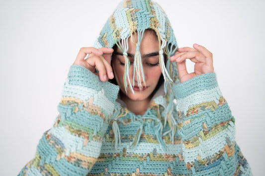 Pastel Static handmade fringed crochet hoodie close-up, hood up with mint and pastel yarn fringe