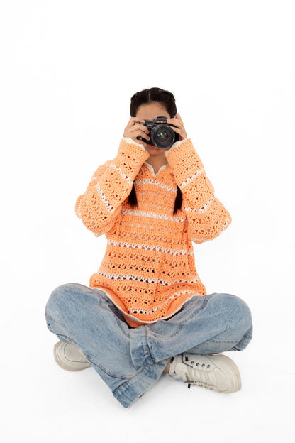 Model seated holding a camera, wearing Peach Please handmade openwork crochet hoodie – POSHERI Loop de Loop