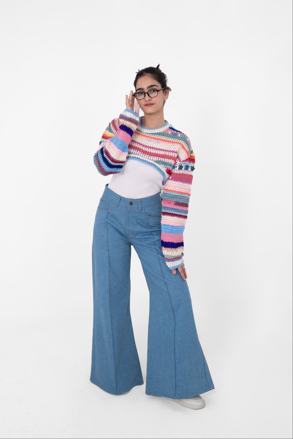 Short Circuit handmade multicolour cropped crochet top in pink, blue, purple and coral stripes, layered over a white top