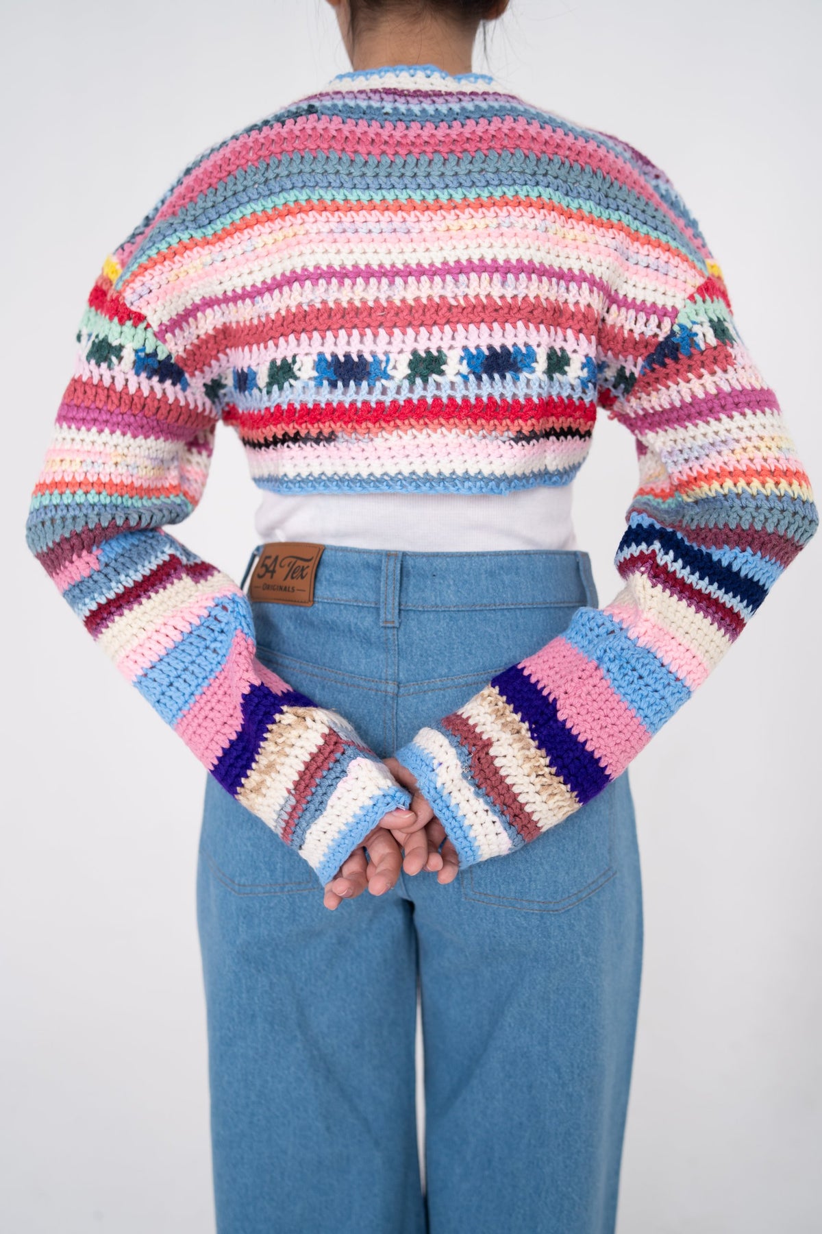 Short Circuit cropped crochet top back view with multicolour stripes and patterned band
