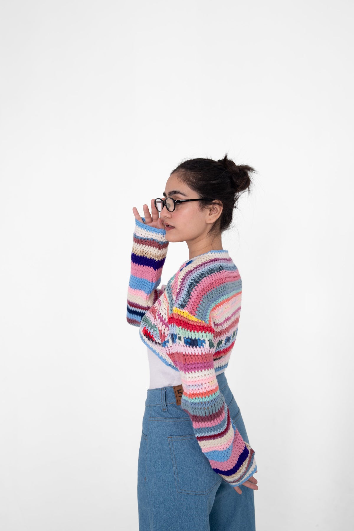 Short Circuit multicolour crochet top side view showing cropped body and long striped sleeves