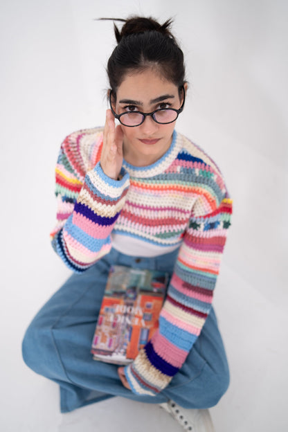 Short Circuit cropped crochet top seen from above, model in glasses holding a book