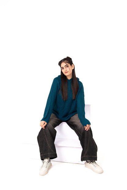 Teal Deal relaxed-fit crochet hoodie, model seated in wide-leg washed black jeans
